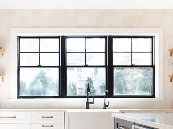 Black windows behind kitchen sink